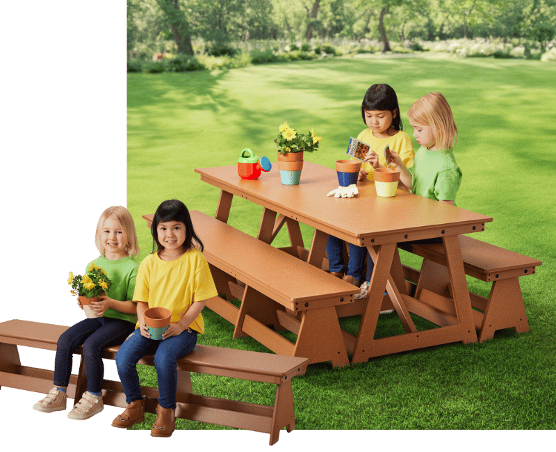 Two preschoolo age children sit at a picnic table for children. 